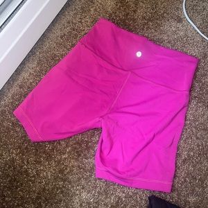Wunder Train High Rise Biker Shorts. Color is Ripened Raspberry.